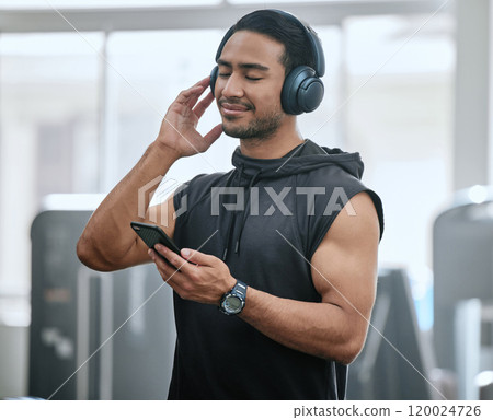 Music, headphones and man with cellphone in gym, athlete and ready for workout, fitness and training. Health club, guy and routine of exercise in morning, ambition and preparing of competition 120024726