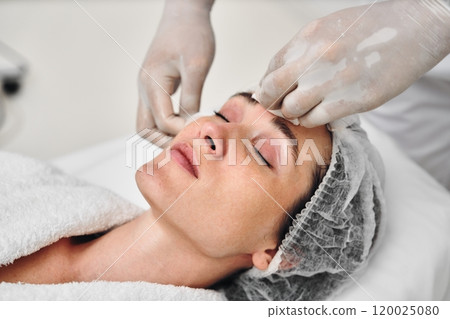 Skincare treatment session at a spa with a relaxed woman lying down Skincare treatment session at a spa with a relaxed woman lying down 120025080