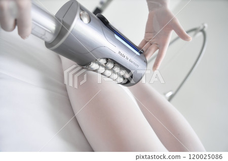 Body contouring treatment session in a wellness center using modern equipment 120025086