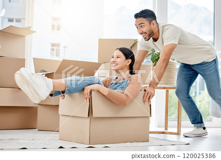 Couple, happy and pushing box for playing together with moving, new property and love bonding in home. Smile, man and woman in cardboard with fun energy for new house, mortgage and relationship trust Couple, happy and pushing box for playing together with moving, new property and love bonding in home. Smile, man and woman in cardboard with fun energy for new house, mortgage and relationship trust 120025386
