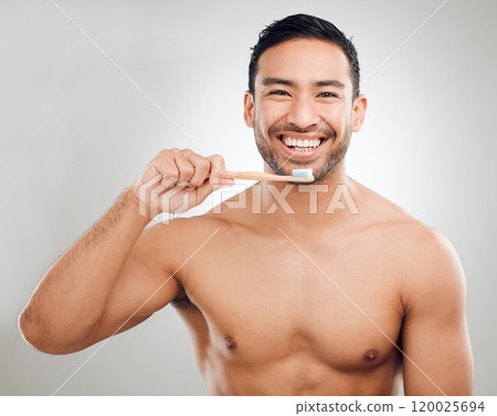 Man, portrait and toothpaste on brush for teeth whitening results with wellness, healthy gums and hygiene in studio. Asian guy, dental product and cleaning mouth for fresh breath by white background Man, portrait and toothpaste on brush for teeth whitening results with wellness, healthy gums and hygiene in studio. Asian guy, dental product and cleaning mouth for fresh breath by white background 120025694