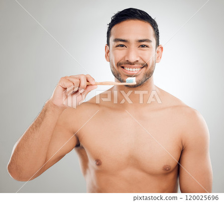 Man, portrait and toothbrush for brushing teeth in studio, grooming and treatment on gray background. Male person, toothpaste and gum health or tooth whitening, plaque and oral or dental healthcare Man, portrait and toothbrush for brushing teeth in studio, grooming and treatment on gray background. Male person, toothpaste and gum health or tooth whitening, plaque and oral or dental healthcare 120025696