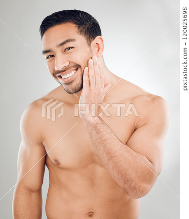 Skincare, hand and portrait of asian man in studio with morning routine for hygiene, wellness or natural treatment on white background. Grooming, body and model for confidence, facial or satisfaction 120025698