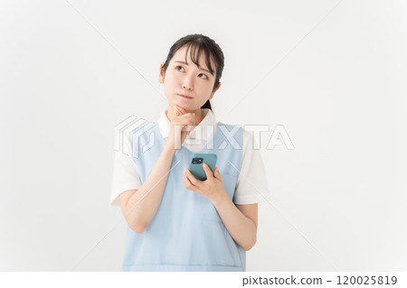 Apron woman, nursery teacher, caregiver, smartphone, worries 120025819