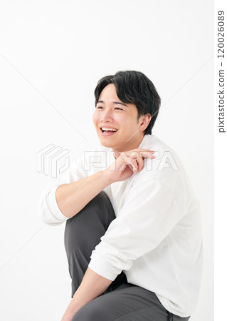 Casual male smiling kneeling 120026089