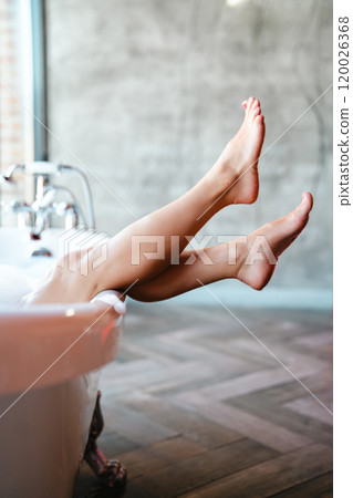 Woman feet in bathrobe at home, closeup 120026368
