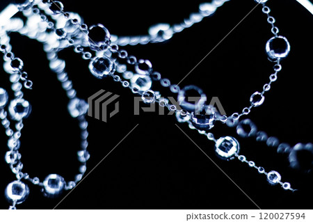Crystal beads hanging disco garland shining on dark background. Christmas, New Year 2025 Crystal beads hanging disco garland shining on dark background. Christmas, New Year 2025 120027594