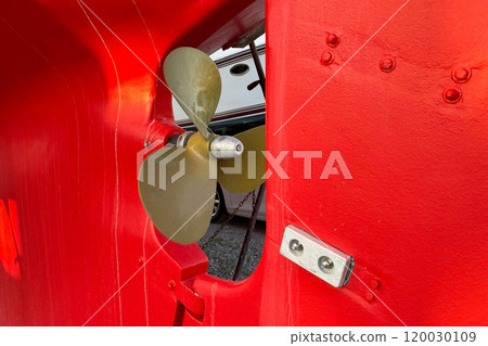 Propeller ship in dry dock. The vessel stands showcasing its structure and intricate details Propeller ship in dry dock. The vessel stands showcasing its structure and intricate details 120030109