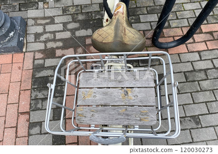 old shabby bicycle saddle and wooden box, urban transport in New York 120030273