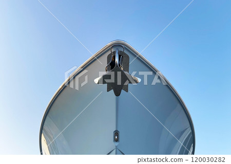 An anchor on cape of the ship close up, luxury yacht leisure motor boat with raised metal anchor An anchor on cape of the ship close up, luxury yacht leisure motor boat with raised metal anchor 120030282
