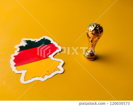 Closeup german flag stickers with world cup trophy on a yellow background. Closeup german flag stickers with world cup trophy on a yellow background. 120030573