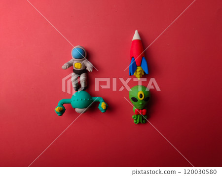 Top view spaceman with space ship,space alien and space rocket on a red background. 120030580