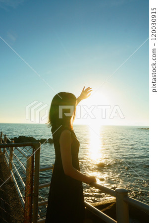 Woman bathing in sunlight at the beach 120030915