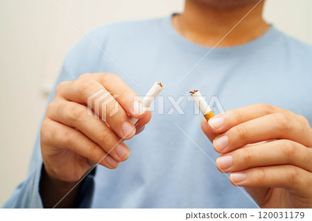 Quit smoking, Asian man breaking destroy cigarette in hand. Quit smoking, Asian man breaking destroy cigarette in hand. 120031179