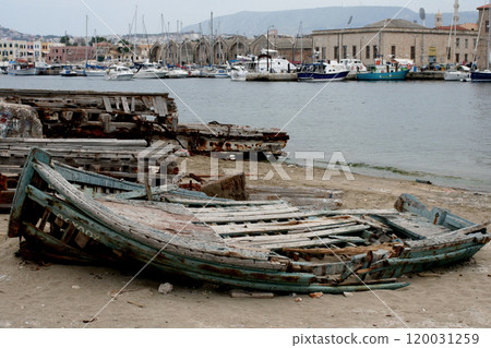 old ruined wooden boat on the shore near the water 120031259