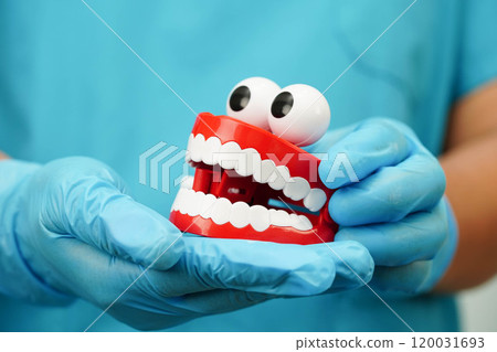 Funny red teeth with eye toy denture model for dental health care. 120031693