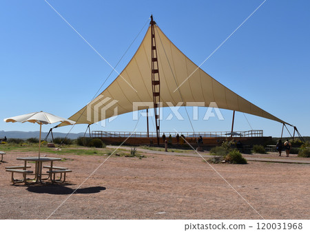 Beige sun shade against the backdrop of the desert 120031968