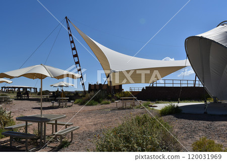 Beige sun shade against the backdrop of the desert 120031969