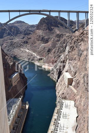 Hoover Dam, Hydroelectric power plant in Clark County, Nevada, industrial construction against the blue sky and mountains Hoover Dam, Hydroelectric power plant in Clark County, Nevada, industrial construction against the blue sky and mountains 120032324