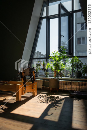 Modern Pilates studio with bright, spacious windows for exercise and wellbeing Modern Pilates studio with bright, spacious windows for exercise and wellbeing 120032356