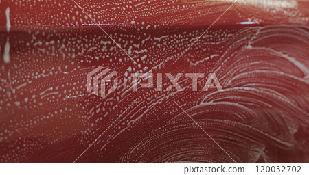 Closeup focus red car wash degreasing paint soak Closeup focus red car wash degreasing paint soak 120032702