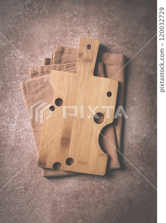 wooden cutting board,rectangular with handle, cheese shape with holes, on a kitchen towel, top view, food background, no people, 120032729