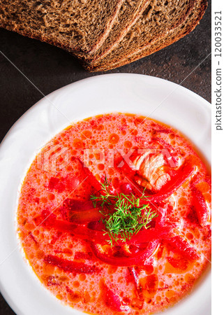 Homemade red beetroot soup on black stone slate background. Traditional Ukrainian borscht with sour cream Homemade red beetroot soup on black stone slate background. Traditional Ukrainian borscht with sour cream 120033521