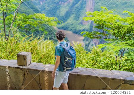 Male tourist exploring Sumidero Canyon National Park, Mexico. Adventure, natural exploration, and travel experience concept Male tourist exploring Sumidero Canyon National Park, Mexico. Adventure, natural exploration, and travel experience concept 120034551