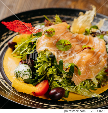 Top view of a gourmet salad with smoked salmon, vibrant greens, and artistic garnishes on table Top view of a gourmet salad with smoked salmon, vibrant greens, and artistic garnishes on table 120034648