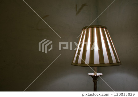 Decorative vintage lamp on top of a table with the light on Decorative vintage lamp on top of a table with the light on 120035029