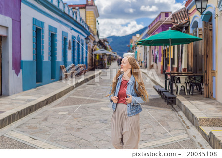 Female tourist walks through the colonial streets San Cristobal de las Casas, Mexico. Cultural exploration, architecture, and travel experience concept Female tourist walks through the colonial streets San Cristobal de las Casas, Mexico. Cultural exploration, architecture, and travel experience concept 120035108