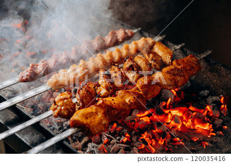 Tender marinated chicken skewers grilling over hot charcoal for a perfect barbecue flavor 120035416