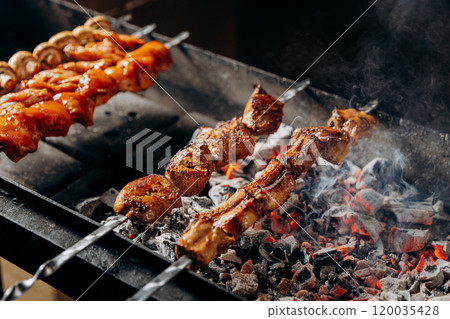 Juicy grilled skewers roasting over hot charcoal, perfect for BBQ lovers and summer gatherings Juicy grilled skewers roasting over hot charcoal, perfect for BBQ lovers and summer gatherings 120035428