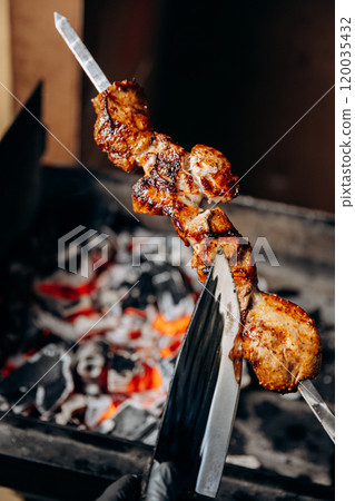 Perfectly grilled skewer with smoky char, fresh off fire for mouth-watering barbecue experience Perfectly grilled skewer with smoky char, fresh off fire for mouth-watering barbecue experience 120035432