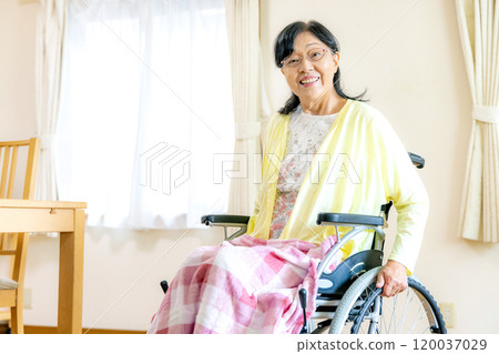 Senior women riding a wheelchair Senior women riding a wheelchair 120037029