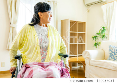 Senior women riding a wheelchair Senior women riding a wheelchair 120037031