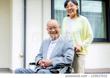 Senior woman sitting in a wheelchair, couple Senior woman sitting in a wheelchair, couple 120037032