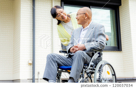 Senior woman sitting in a wheelchair, couple Senior woman sitting in a wheelchair, couple 120037034