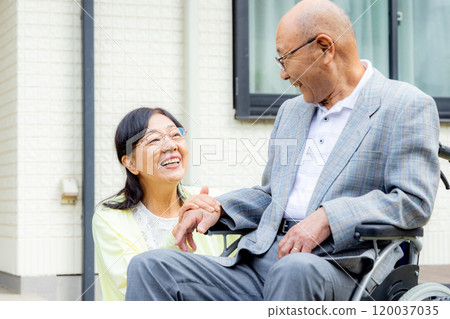 Senior woman sitting in a wheelchair, couple Senior woman sitting in a wheelchair, couple 120037035
