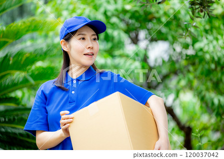 A courier female driver delivering a package 120037042