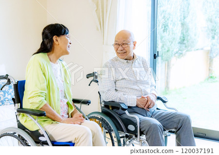 Senior man and woman in wheelchairs Senior man and woman in wheelchairs 120037191
