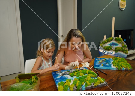 A mother and her daughter craft vibrant natural landscapes A mother and her daughter craft vibrant natural landscapes 120037242