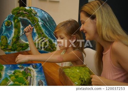 A mother and her daughter craft vibrant natural landscapes A mother and her daughter craft vibrant natural landscapes 120037253