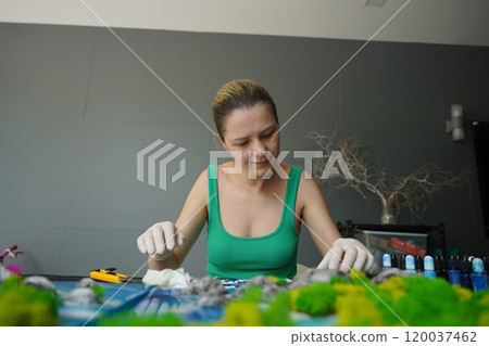The process of making the art decor of epoxy resin, natural stones and moss 120037462