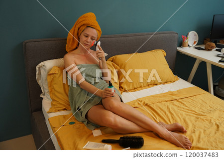 Young woman using infrared massager  120037483