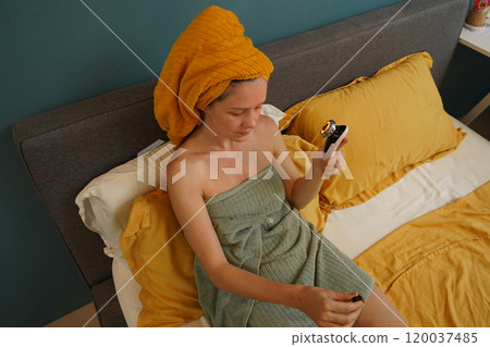 Young woman using infrared massager  120037485