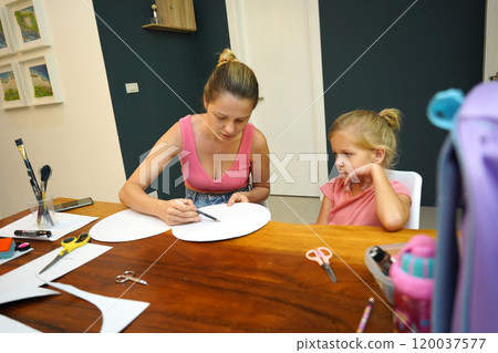 A mother and her young daughter engage in a colorful painting activity A mother and her young daughter engage in a colorful painting activity 120037577