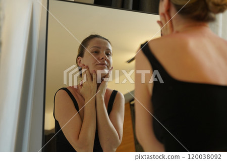 A young woman is enjoying a wonderfully serene morning in her bedroomnd  120038092