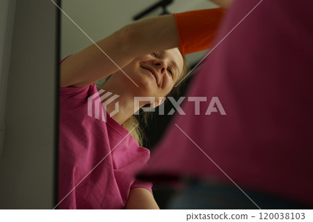 A woman is cleaning her living room at home A woman is cleaning her living room at home 120038103