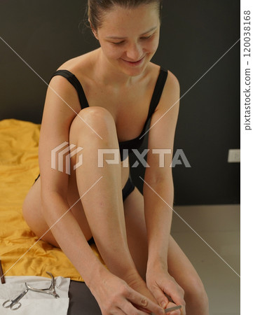 A woman doing a manicure and pedicure 120038168